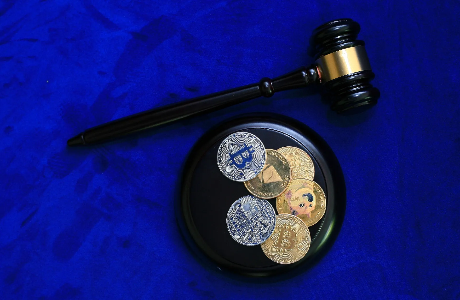 Judge's gavel above a dish of crypto coins